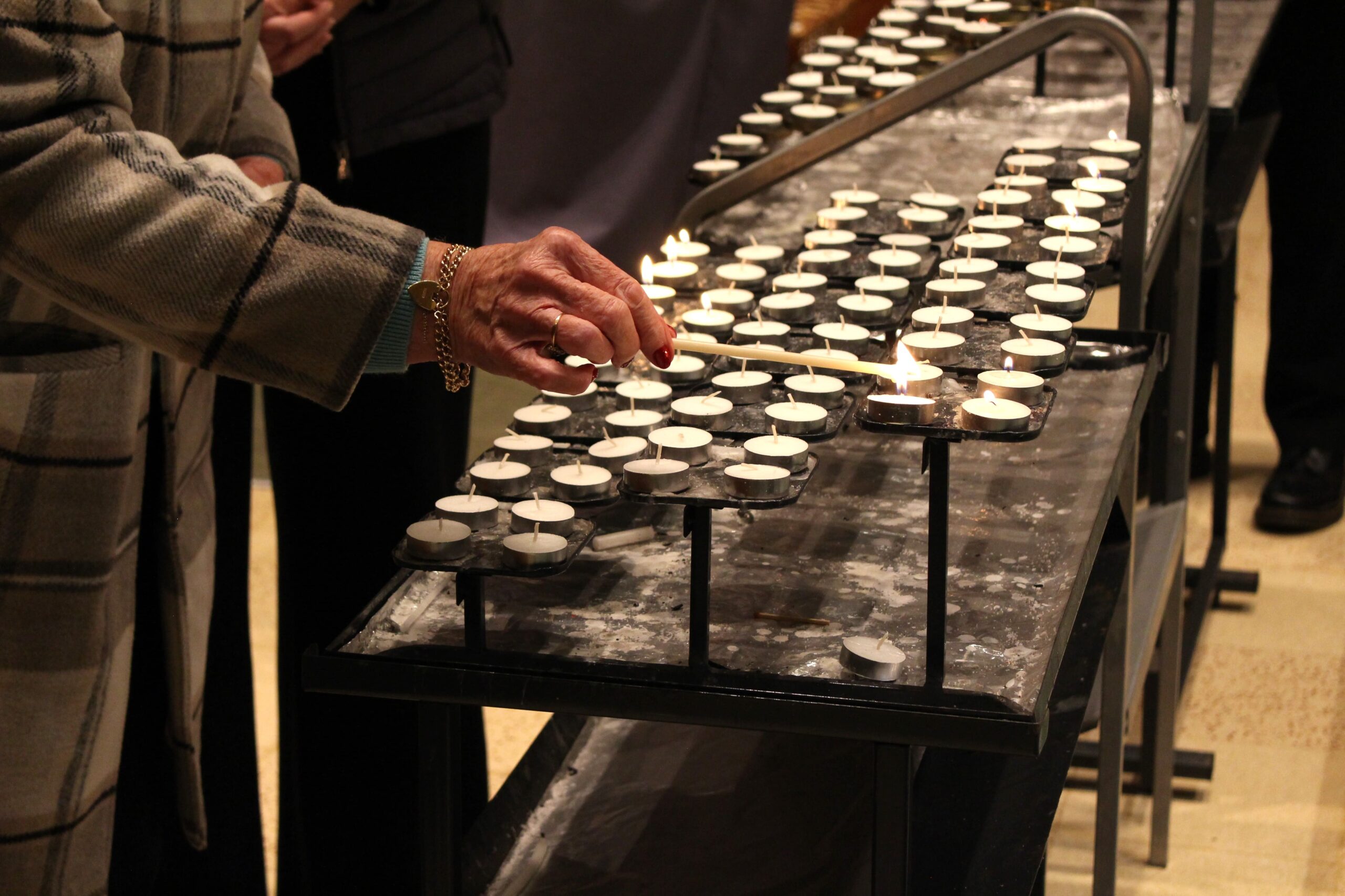 Person lighting a candle