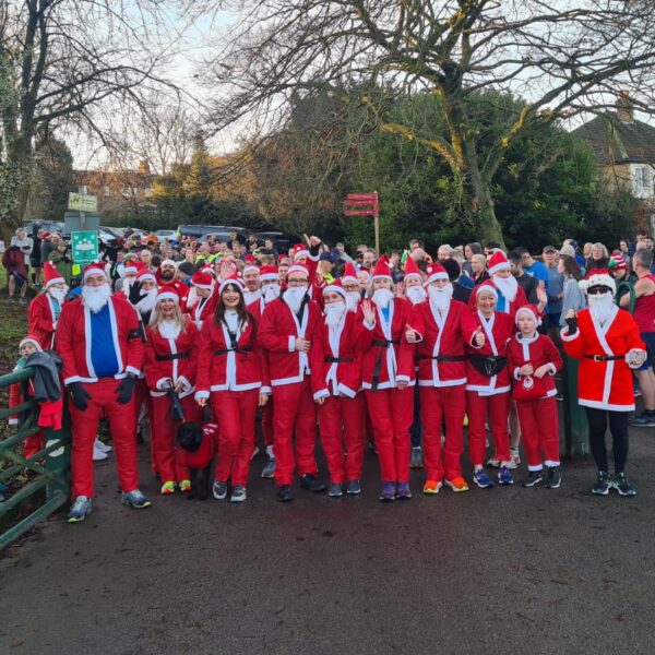 Crowd of people in santa suits