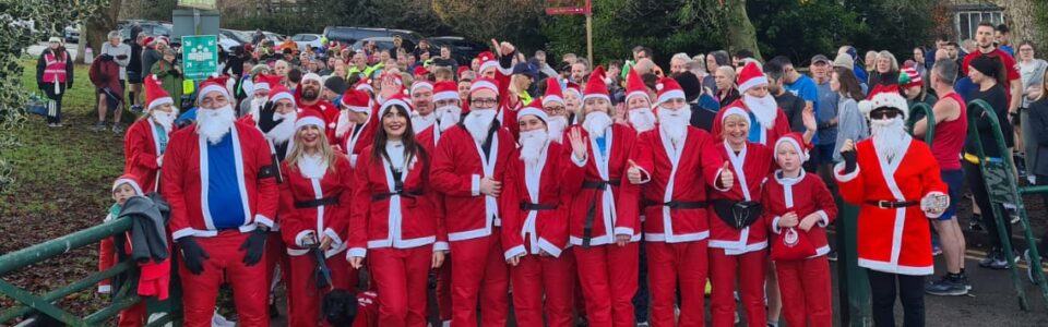 Crowd of people in santa suits