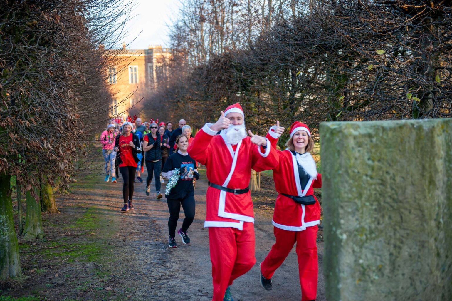 People running in santa suits