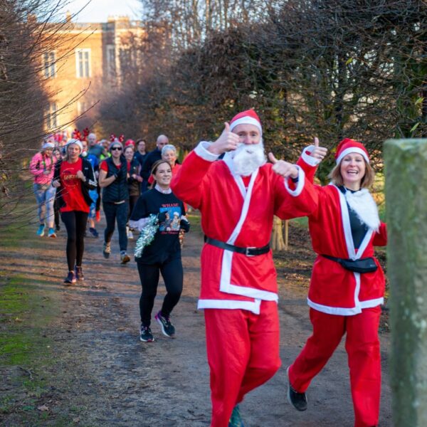 People running in santa suits