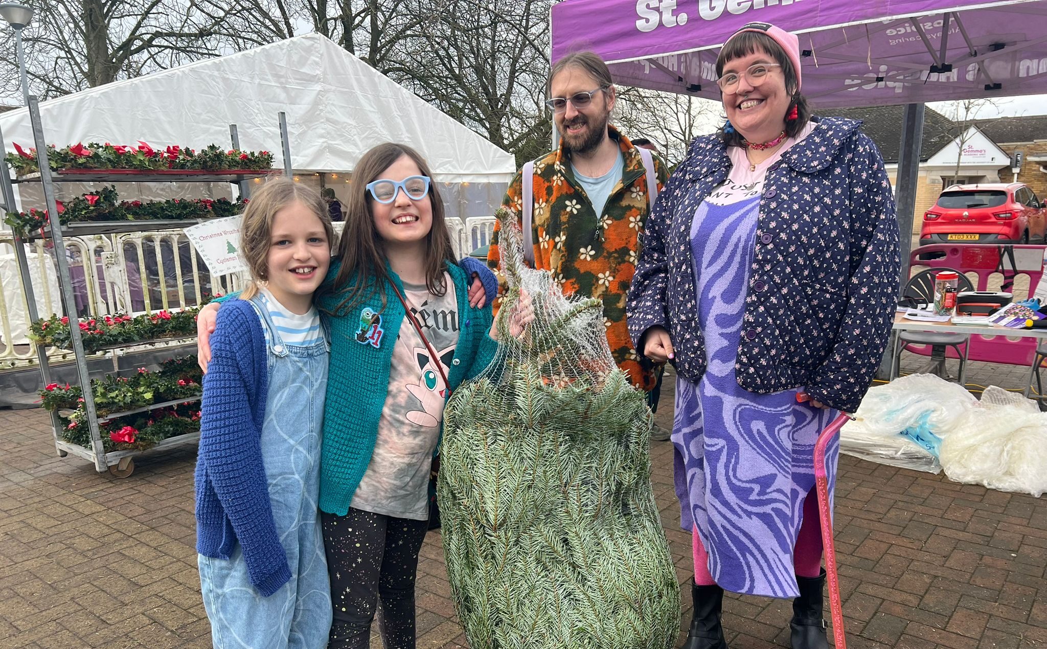 Family holding up their christmas tree