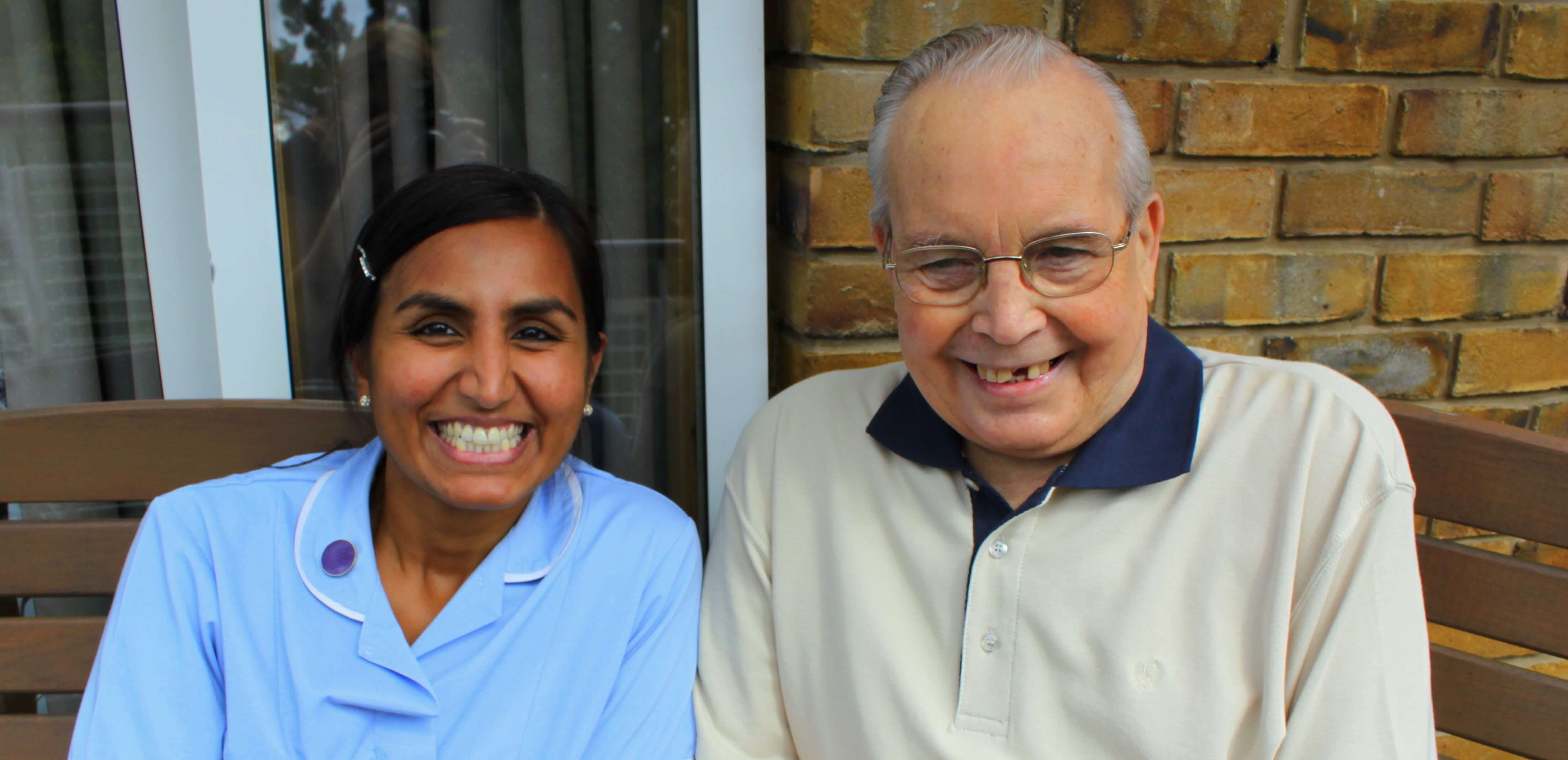 Nurse and patient smiling on terrace